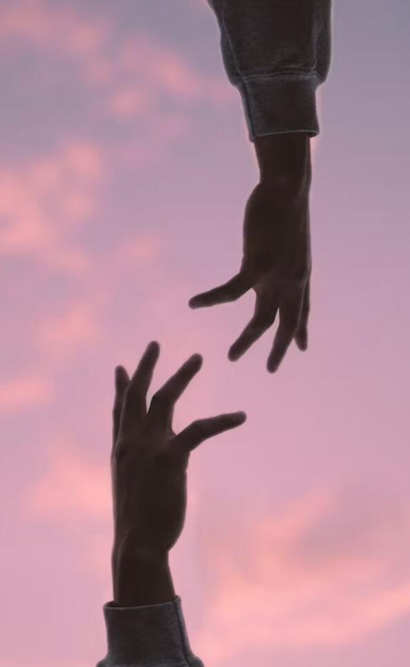 Two hands reaching toward each other, symbolizing support in recovery